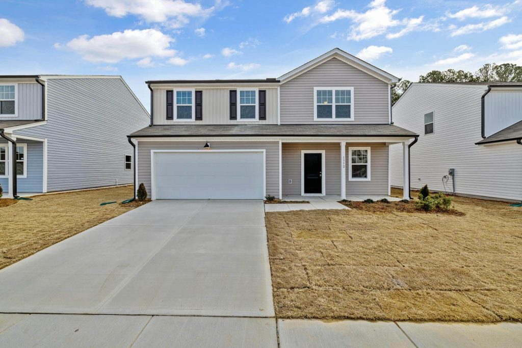 New two-storey home with a straight concrete driveway to a white garage door